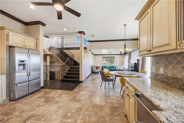 a kitchen with stainless steel appliances granite countertop a sink a stove and a refrigerator