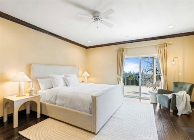 a bedroom with a large bed and a chandelier