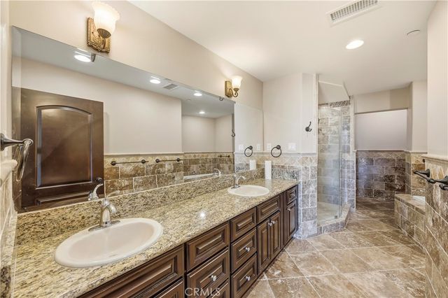 a bathroom with double vanity sinks double vanity shower and a bathtub