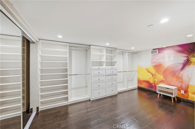 a view of an empty room with a cabinet and a window
