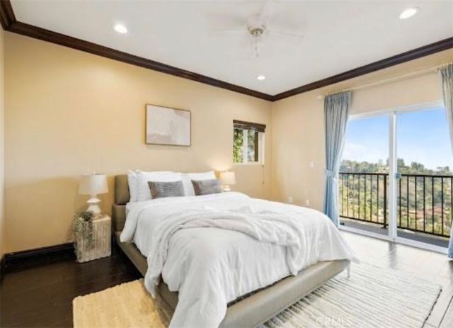 a spacious bedroom with a bed and glass door
