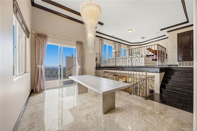a dining room with furniture and a floor to ceiling window