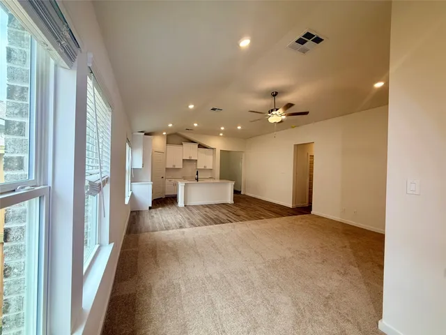 a view of a hallway with a livingroom and furniture