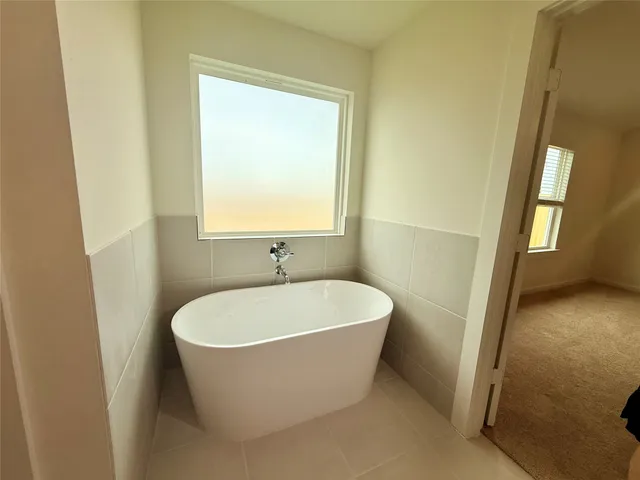 a white bath tub sitting in a bathroom