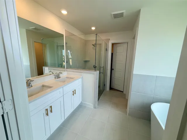 a bathroom with a double vanity sink and mirror