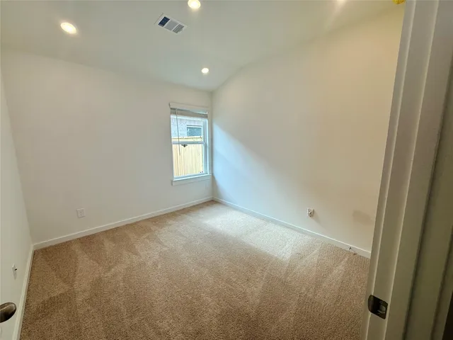 a view of an empty room and a window