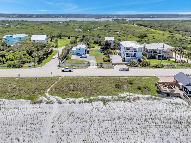 an aerial view of residential houses with outdoor space
