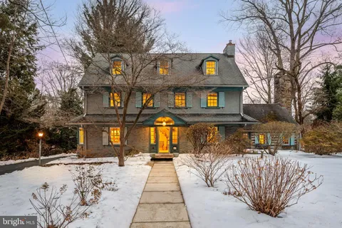 a front view of a building with streets and trees