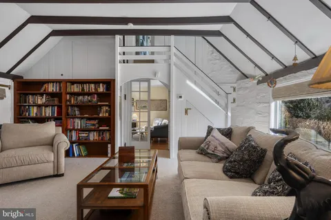a view of a a dining room with furniture window and wooden floor
