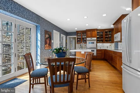 a kitchen with stainless steel appliances granite countertop sink stove top oven and cabinets