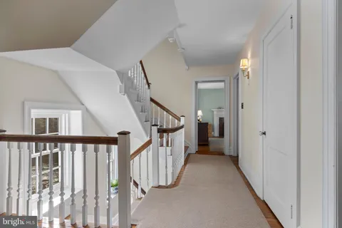 a spacious bathroom with a granite countertop sink mirror and a toilet