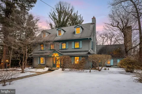 a view of a cafe with table and chairs under an umbrella