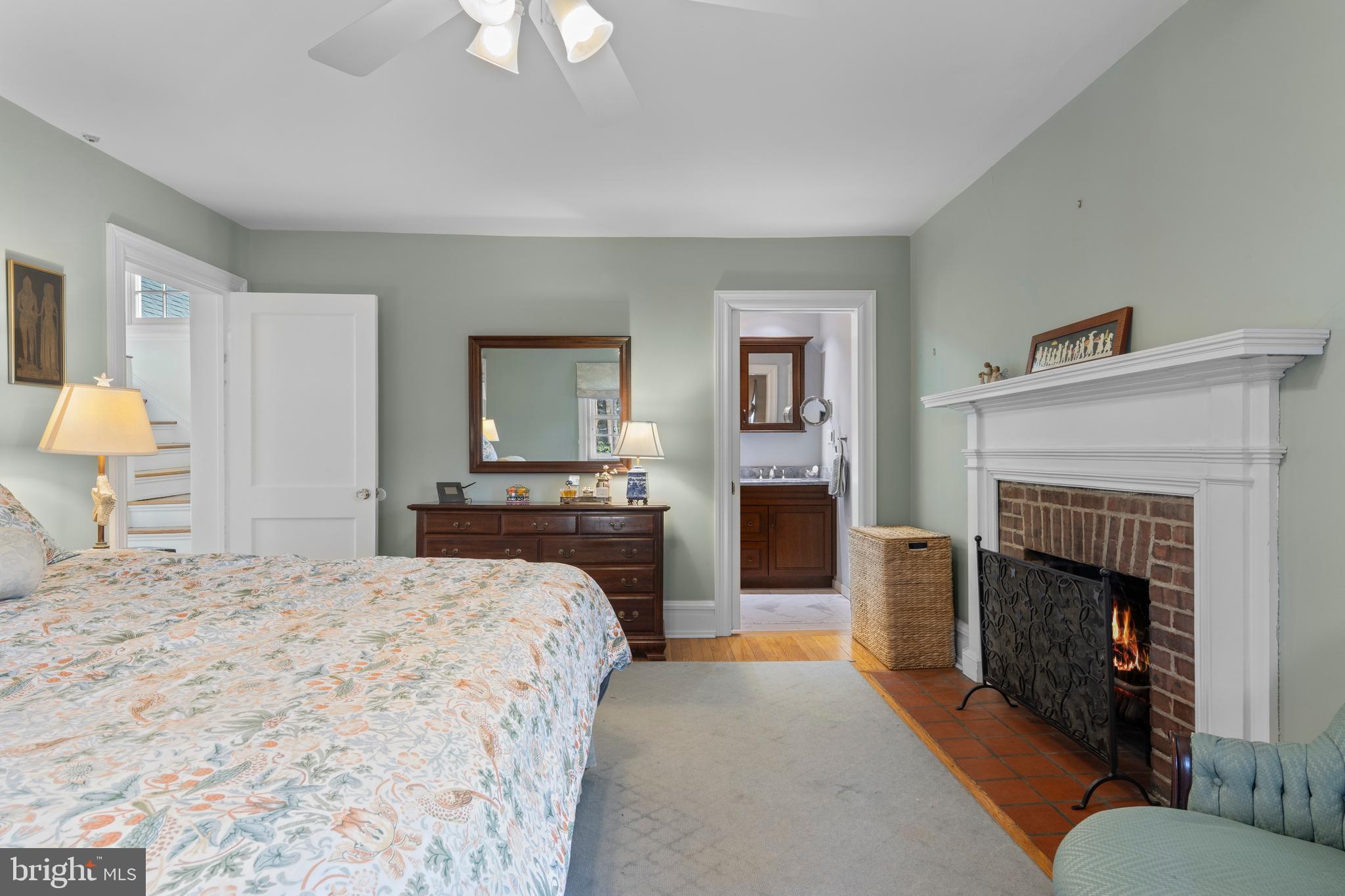 345 Llandrillo Road Bala Cynwyd, PA 19004 - Photo 32 of 54 a spacious bedroom with a bed and a fireplace