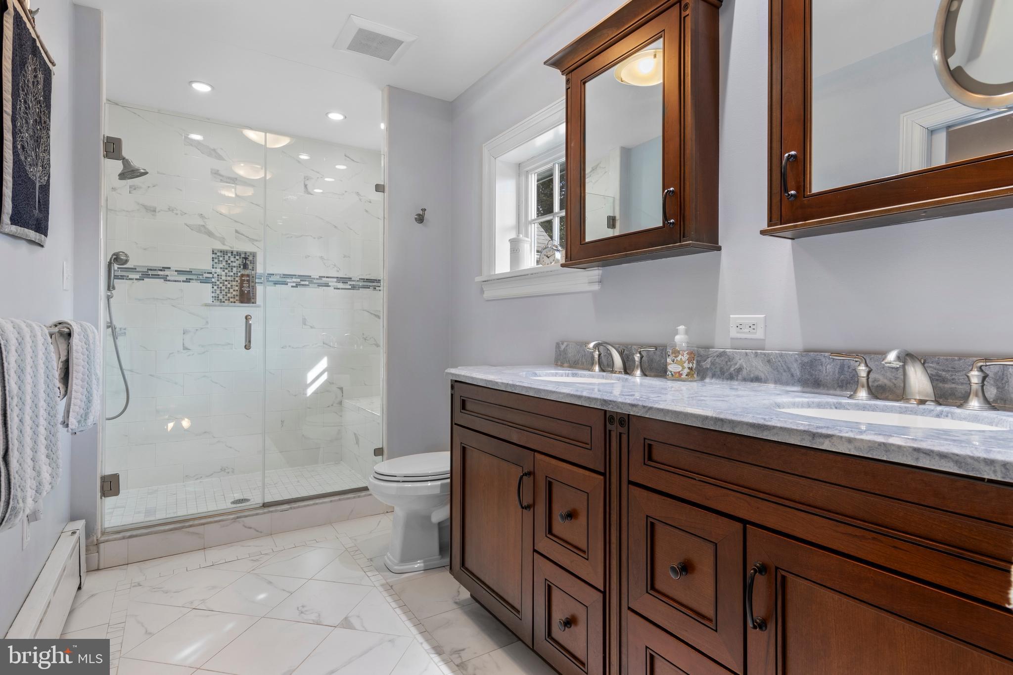 345 Llandrillo Road Bala Cynwyd, PA 19004 - Photo 35 of 54 a spacious bathroom with a granite countertop sink mirror and a toilet