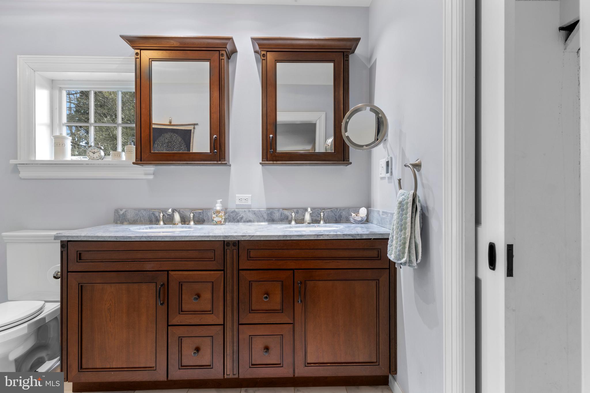 345 Llandrillo Road Bala Cynwyd, PA 19004 - Photo 36 of 54 a bathroom with a granite countertop sink and a mirror