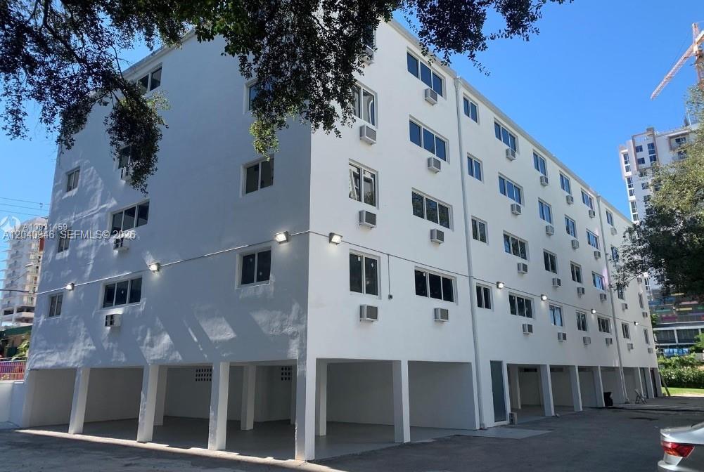 143 Southwest 9th Street, Unit 301 Miami, FL 33130 - Photo 12 of 16 a large building with a clock on the side of it