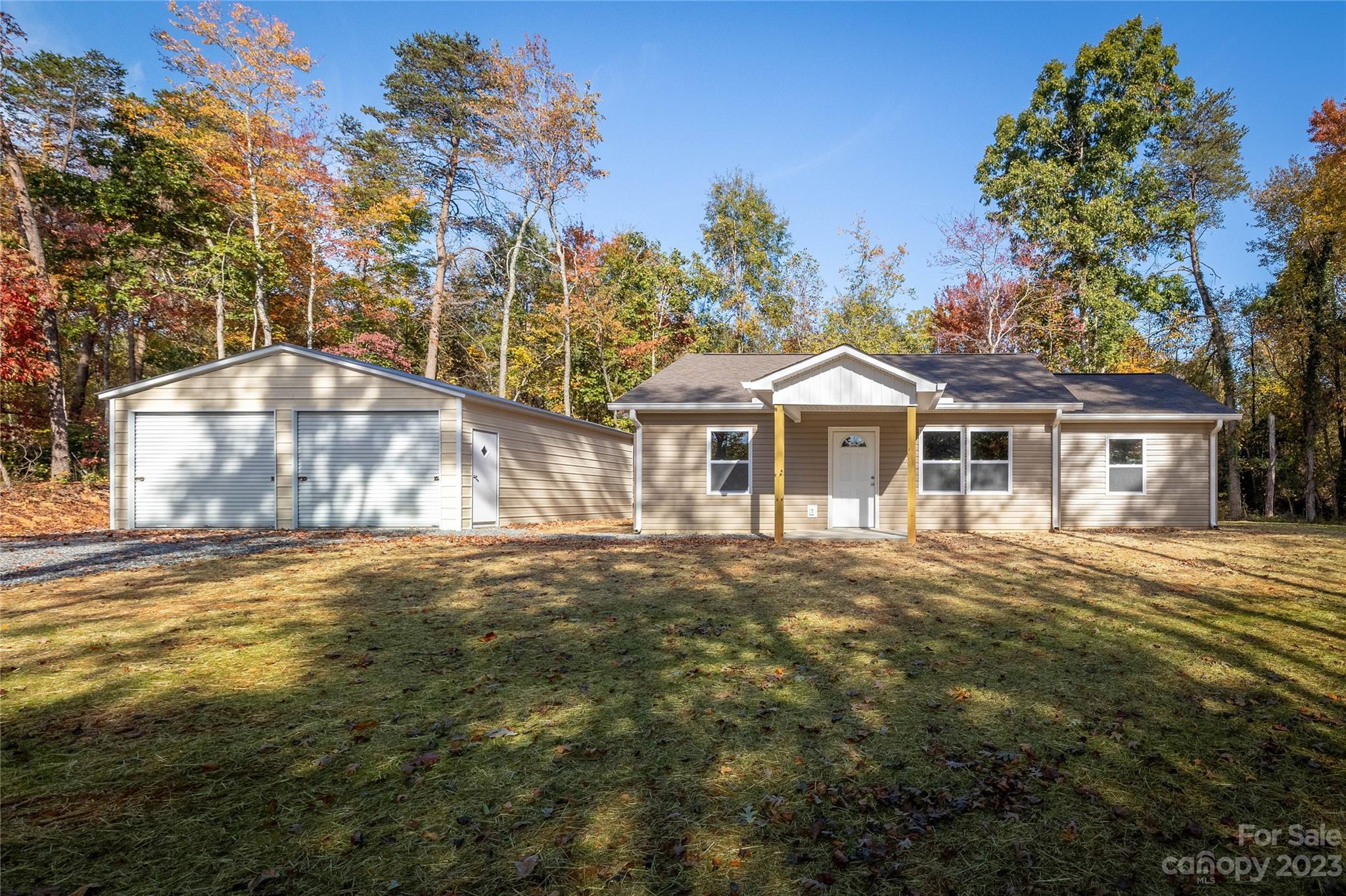 1237 Coffey Road Morganton, NC 28655 - Photo 1 of 19 a front view of a house with a garden