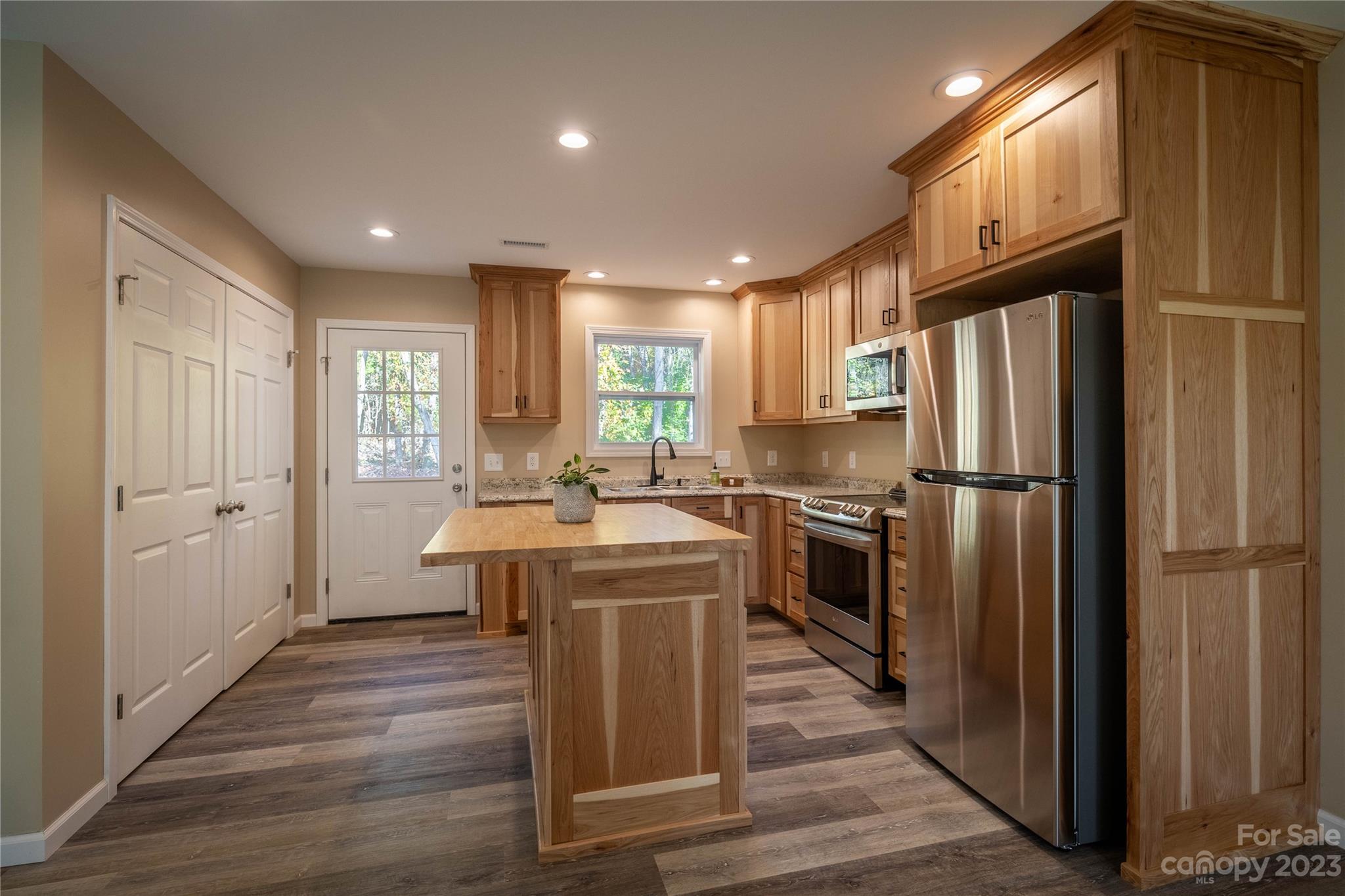 1237 Coffey Road Morganton, NC 28655 - Photo 7 of 19 a kitchen with stainless steel appliances granite countertop a refrigerator a sink dishwasher a stove and a refrigerator
