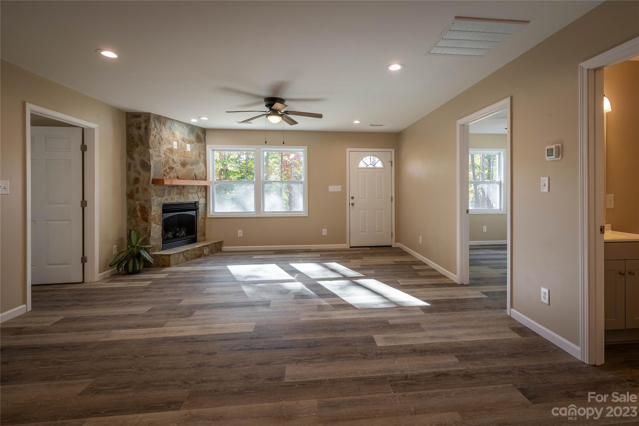 1237 Coffey Road Morganton, NC 28655 - Photo 8 of 19 a view of an empty room with wooden floor and a fireplace