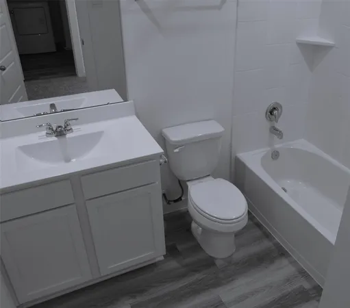 a bathroom with a sink toilet and vanity