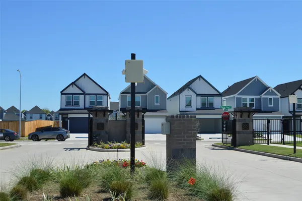 a front view of a house with large windows and a road