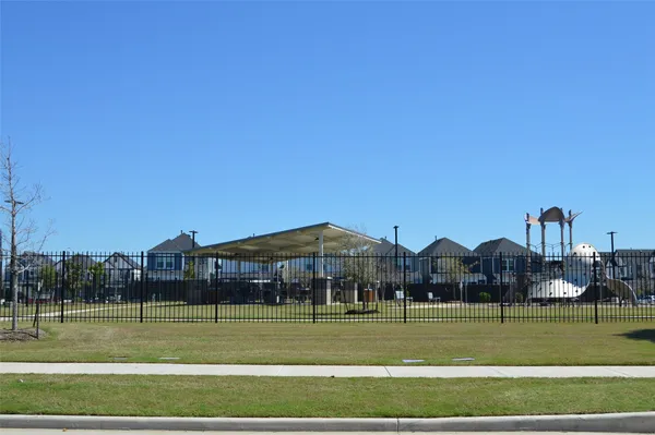 a view of big and white house in a big yard with a big house