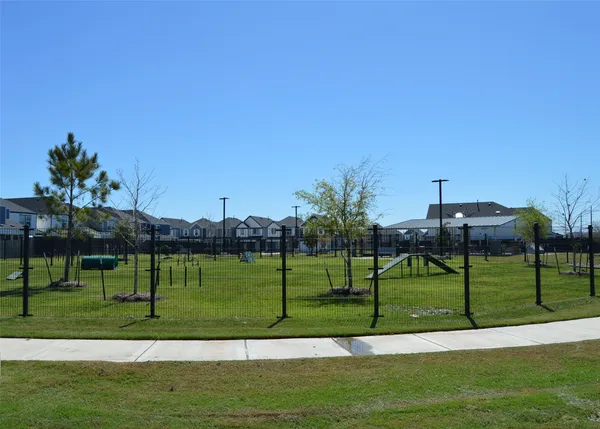 a sign board with a play ground in the back