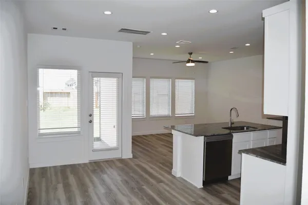 a kitchen with granite countertop a sink and a stove top oven