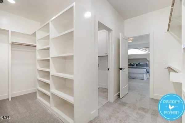 a view of a hallway with wooden shelves