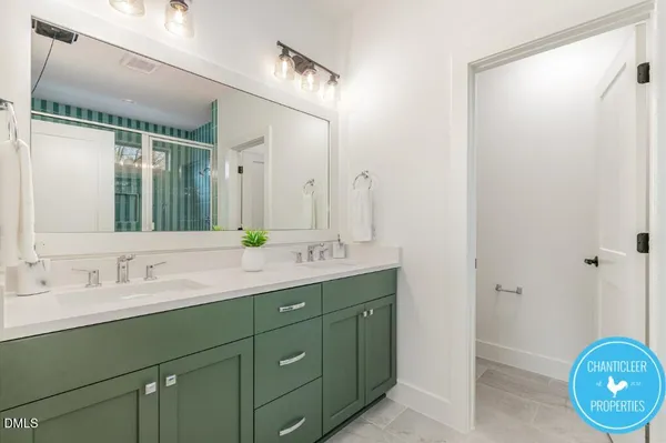 a bathroom with a double vanity sink and a mirror
