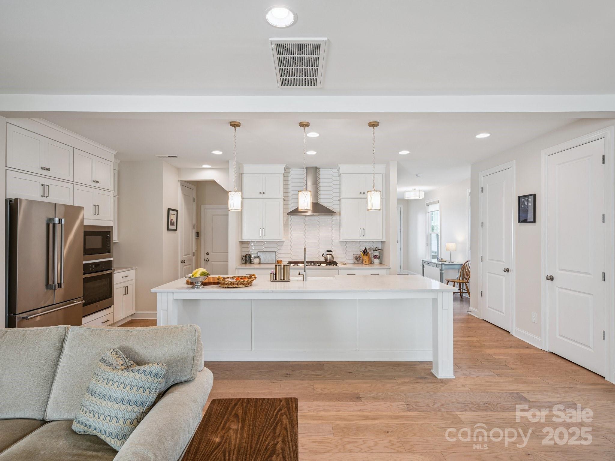 4013 Ashton Ridge Lane Charlotte, NC 28226 - Photo 12 of 36 a living room with stainless steel appliances kitchen island furniture and a view of kitchen