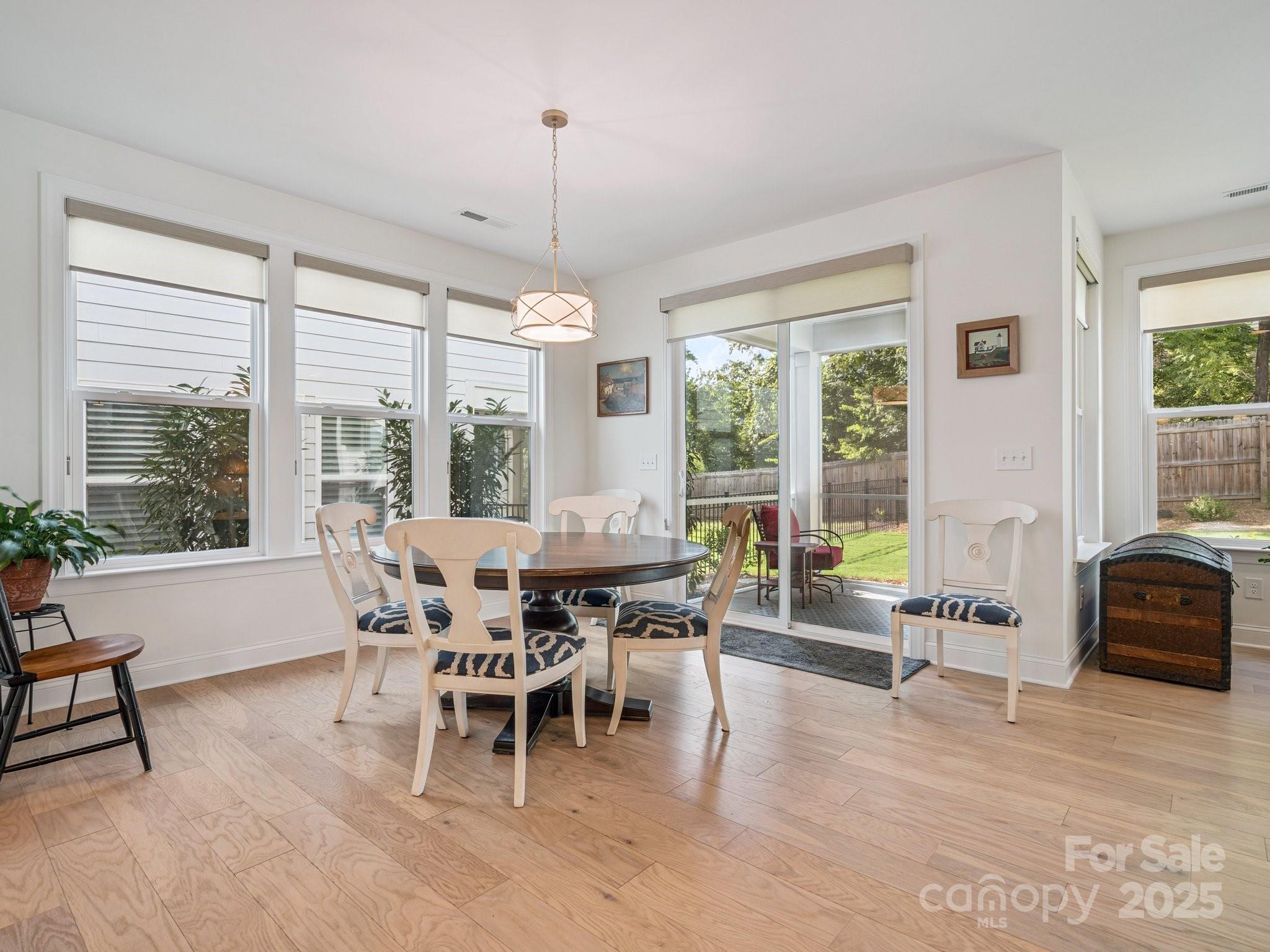 4013 Ashton Ridge Lane Charlotte, NC 28226 - Photo 15 of 36 a dining room with furniture and large windows