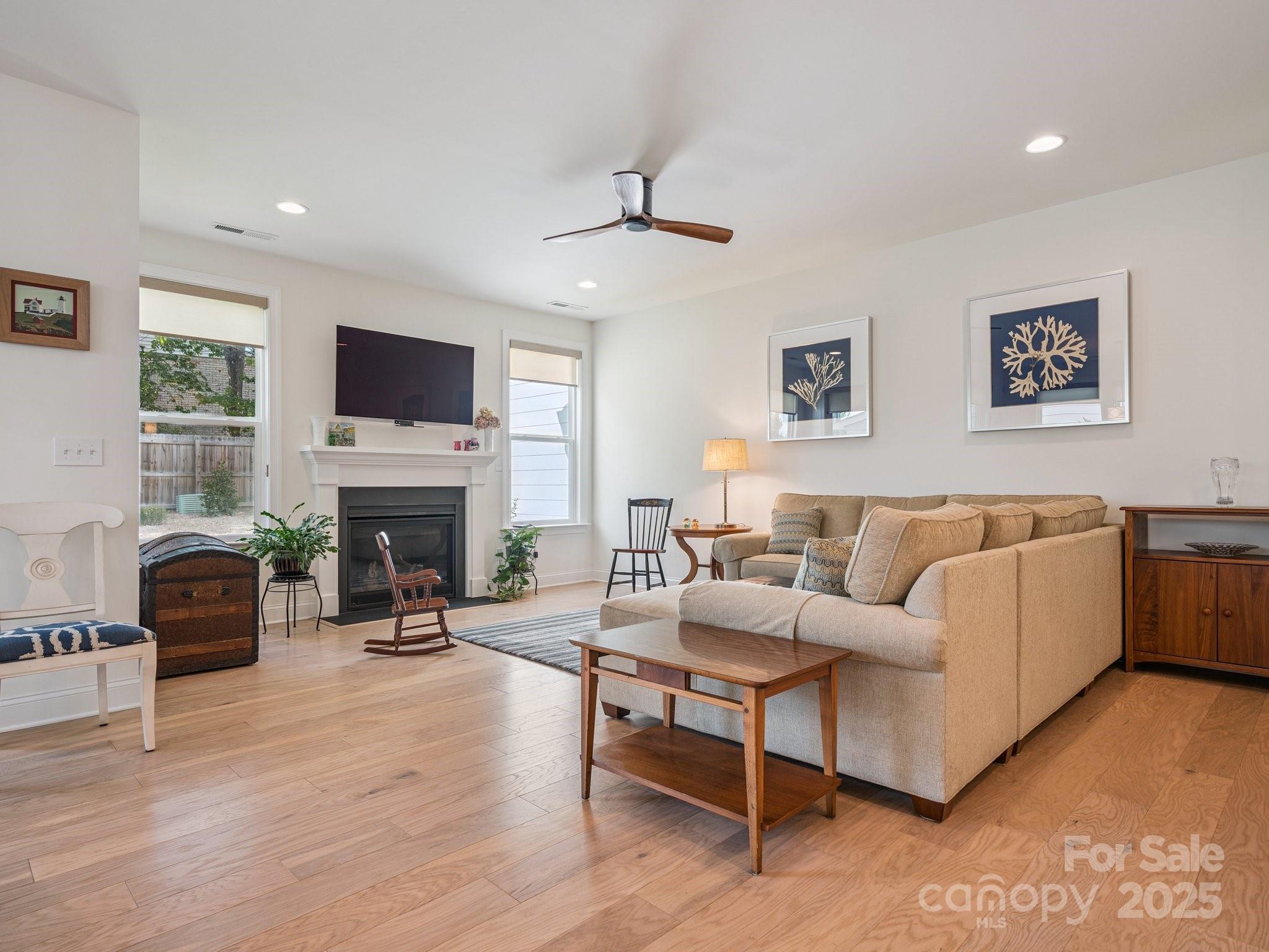 4013 Ashton Ridge Lane Charlotte, NC 28226 - Photo 18 of 36 a living room with furniture a fireplace and a flat screen tv