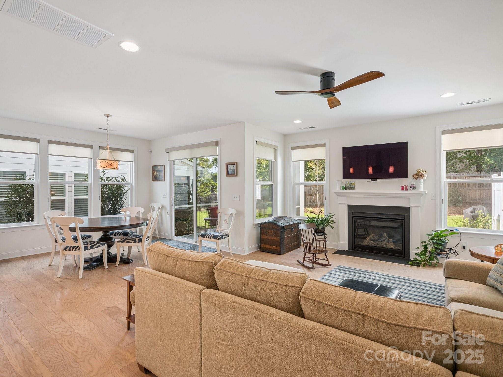 4013 Ashton Ridge Lane Charlotte, NC 28226 - Photo 19 of 36 a living room with furniture a fireplace and a floor to ceiling window