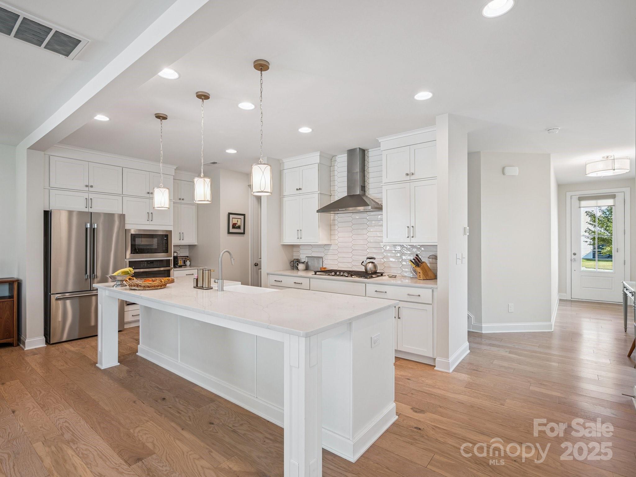 4013 Ashton Ridge Lane Charlotte, NC 28226 - Photo 2 of 36 a large kitchen with stainless steel appliances kitchen island a stove a refrigerator a sink a oven and a refrigerator