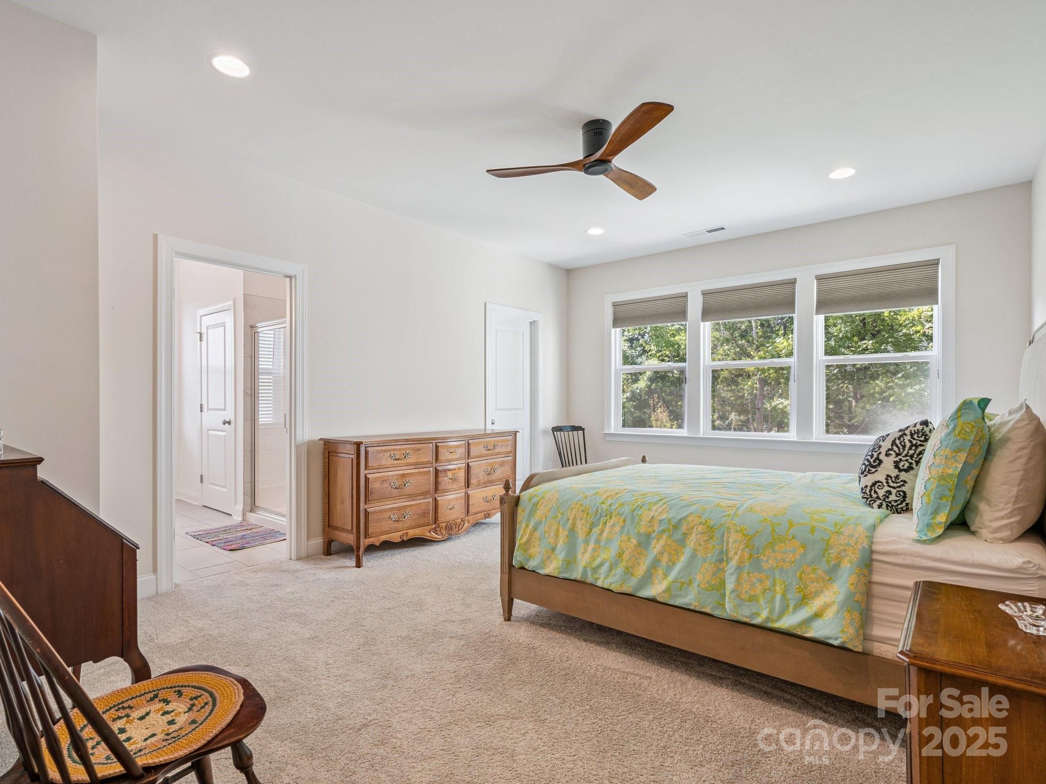 4013 Ashton Ridge Lane Charlotte, NC 28226 - Photo 21 of 36 a bed room with a bed and a chair