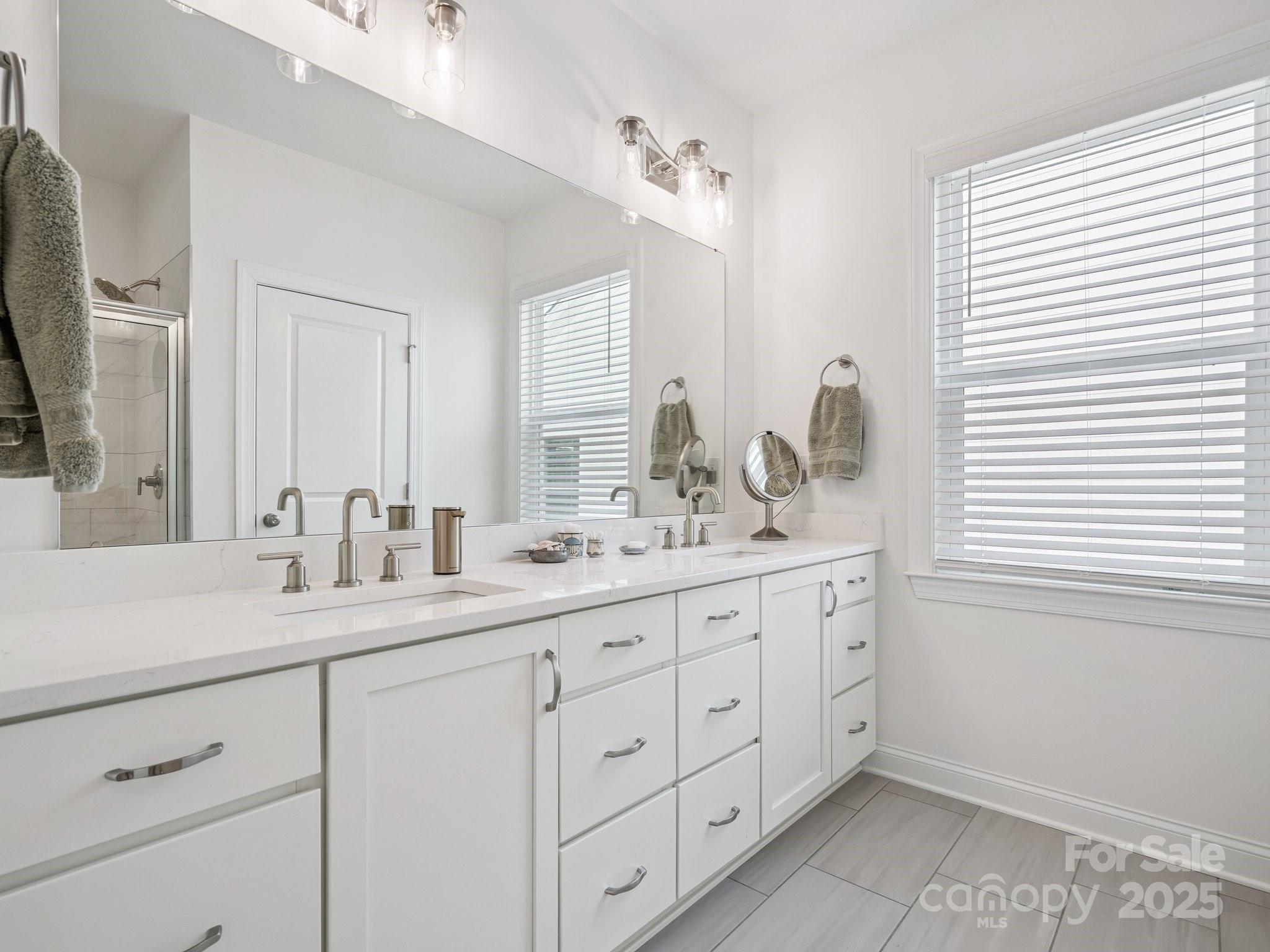 4013 Ashton Ridge Lane Charlotte, NC 28226 - Photo 23 of 36 a bathroom with double sink and a mirror