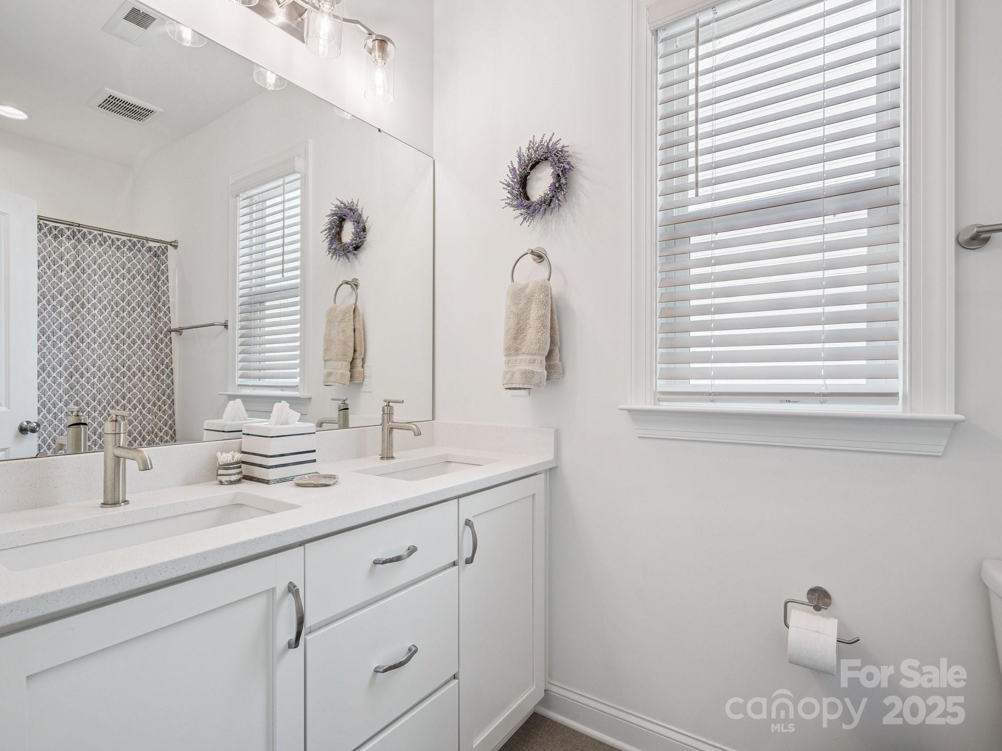 4013 Ashton Ridge Lane Charlotte, NC 28226 - Photo 26 of 36 a bathroom with a sink and a mirror