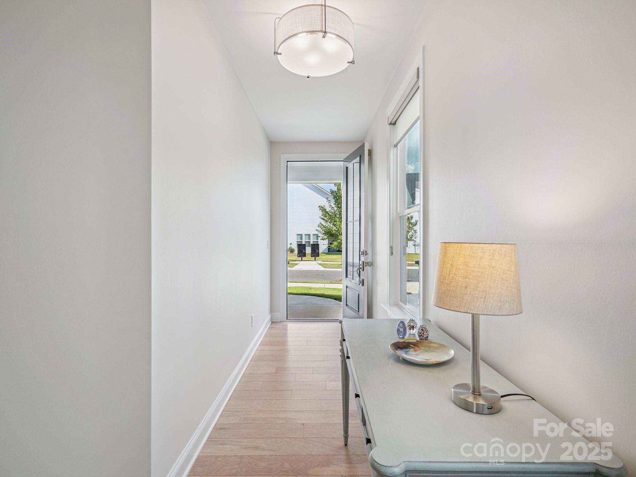 4013 Ashton Ridge Lane Charlotte, NC 28226 - Photo 3 of 36 a view of a hallway with paintings on the walls