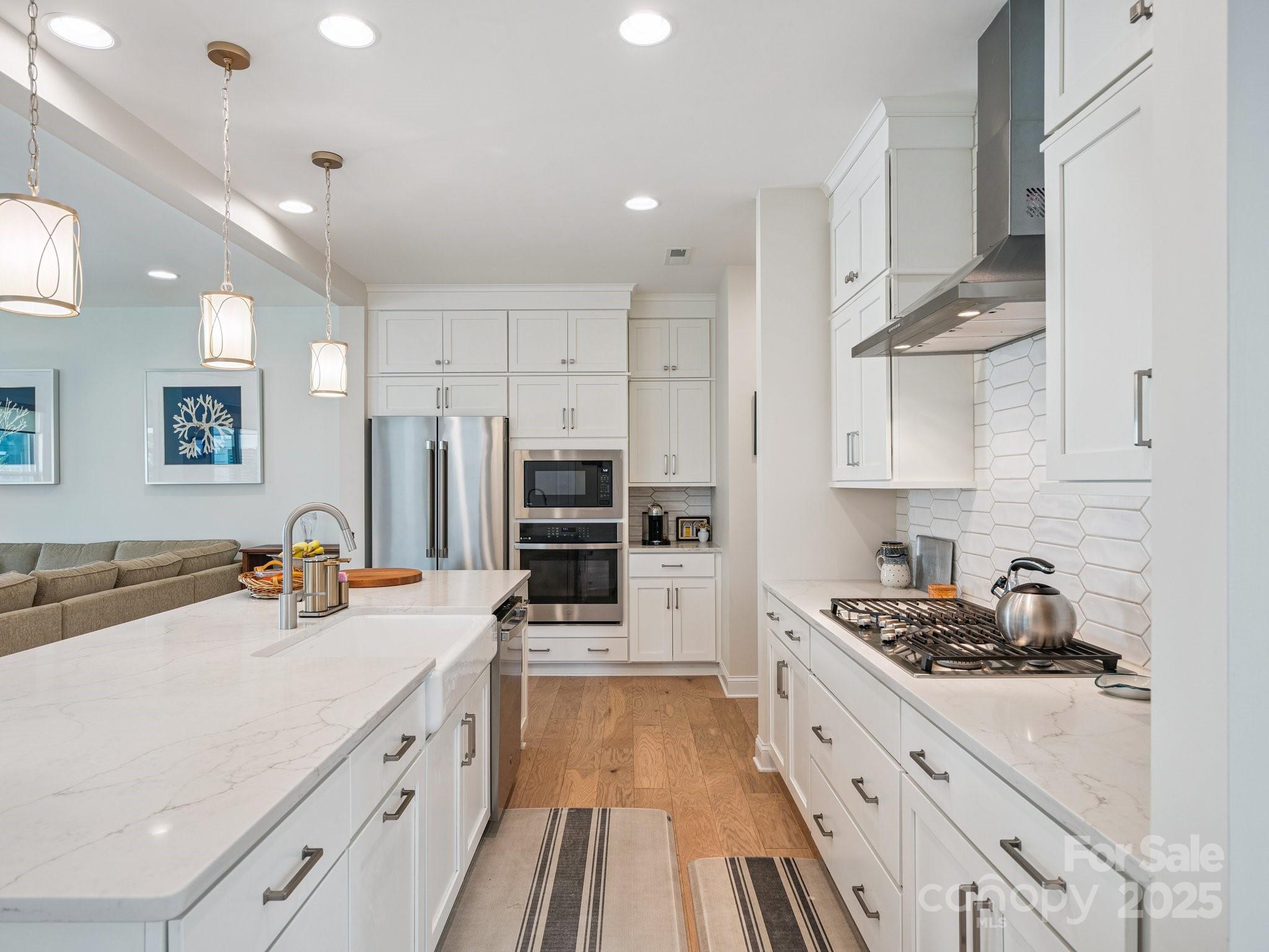 4013 Ashton Ridge Lane Charlotte, NC 28226 - Photo 7 of 36 a kitchen with stainless steel appliances a sink stove and refrigerator