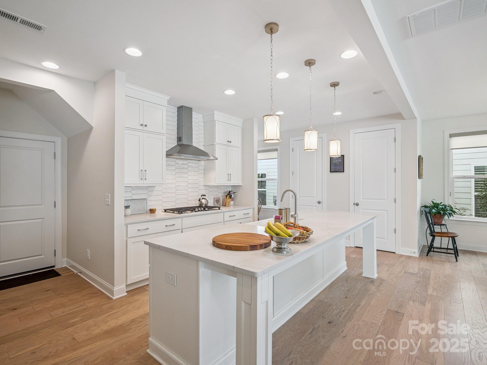 4013 Ashton Ridge Lane Charlotte, NC 28226 - Photo 8 of 36 a kitchen with a stove a refrigerator and a wooden floor