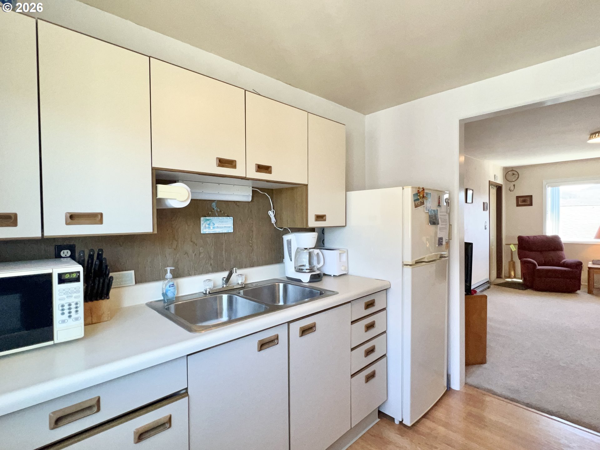 40 Avenue U, Unit 63 Seaside, OR 97138 - Photo 13 of 45 a kitchen with refrigerator and white cabinets