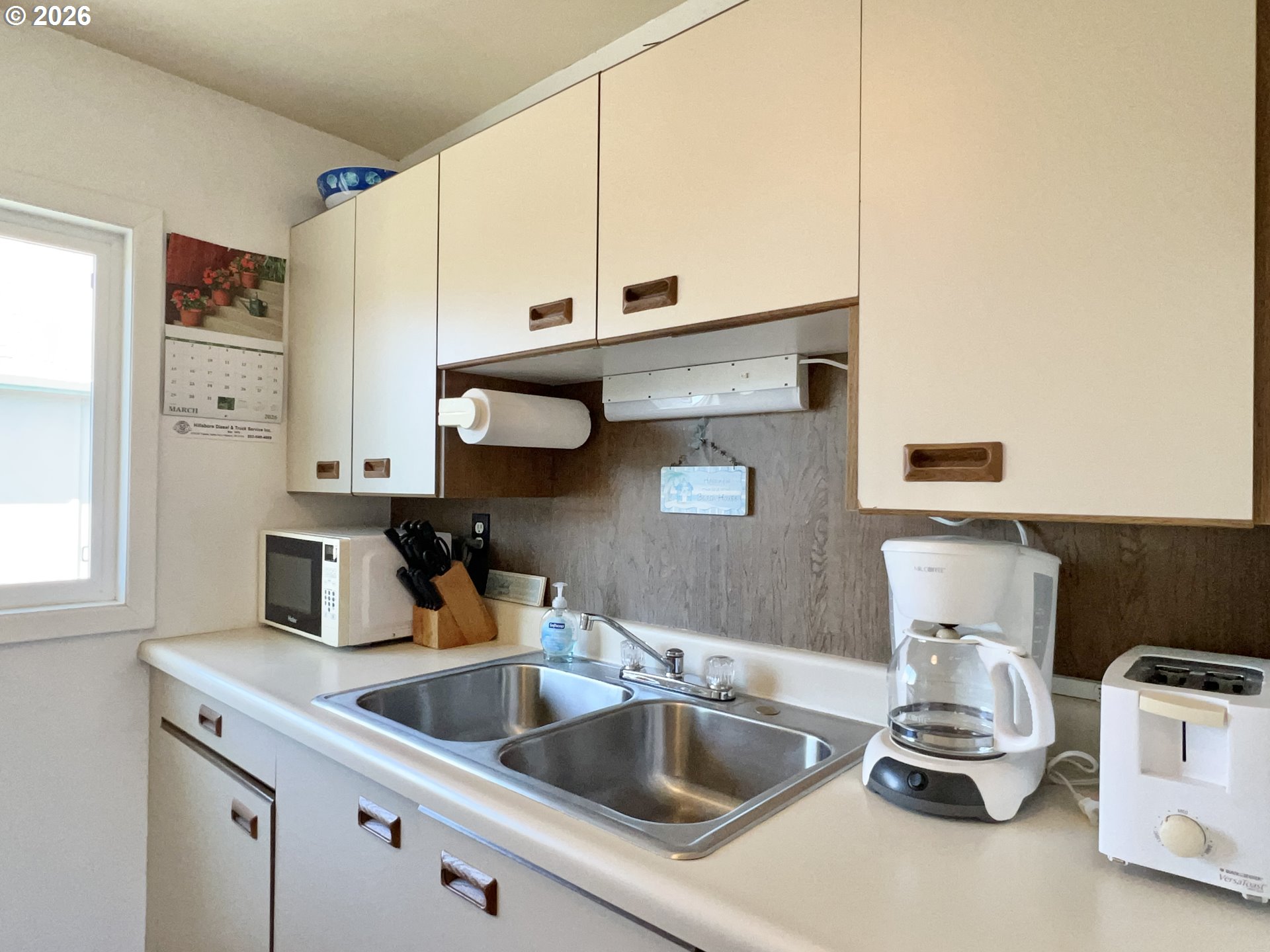 40 Avenue U, Unit 63 Seaside, OR 97138 - Photo 17 of 45 a kitchen with a sink cabinets and a window