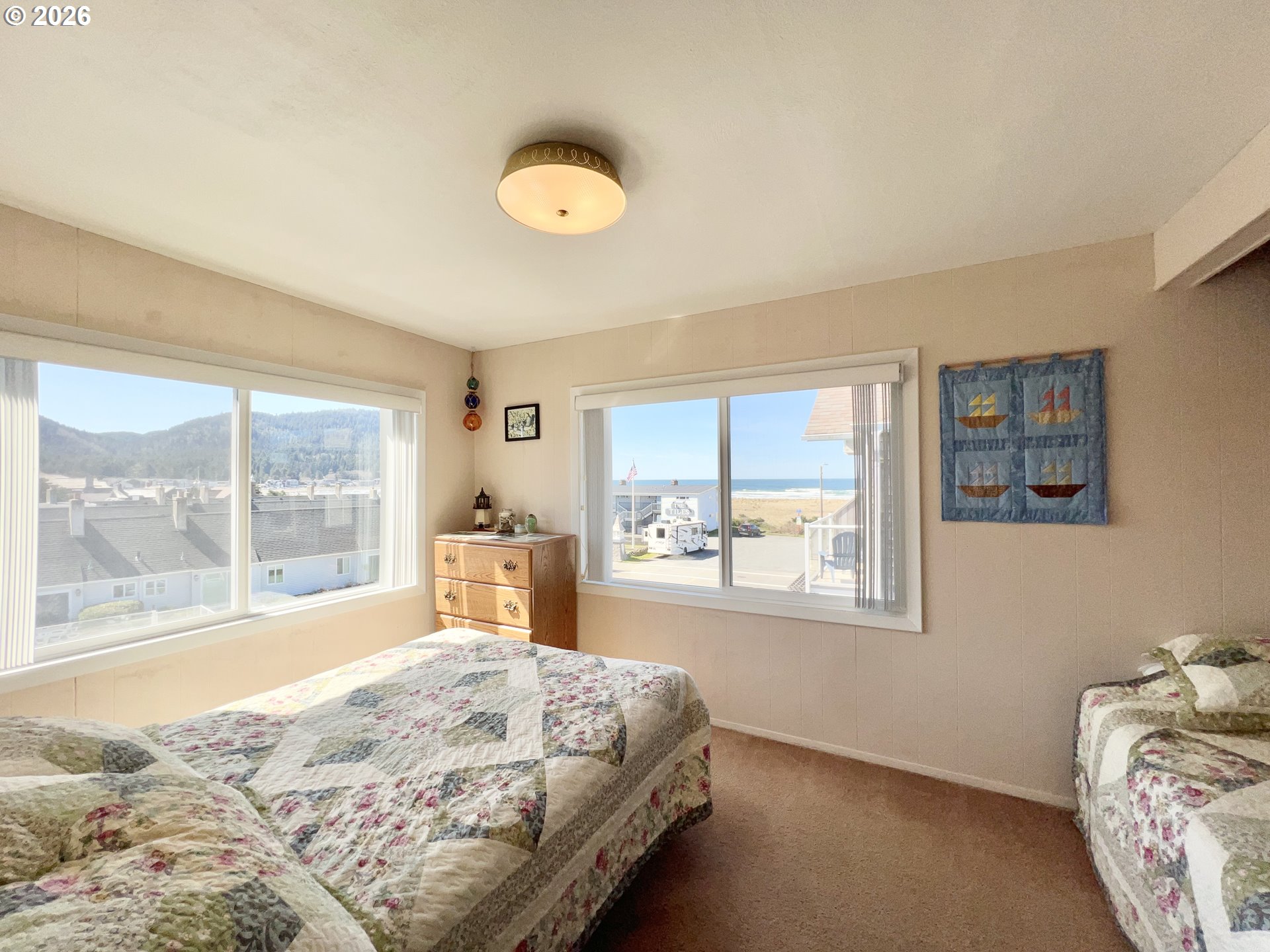 40 Avenue U, Unit 63 Seaside, OR 97138 - Photo 19 of 45 a bedroom with a bed and a large window