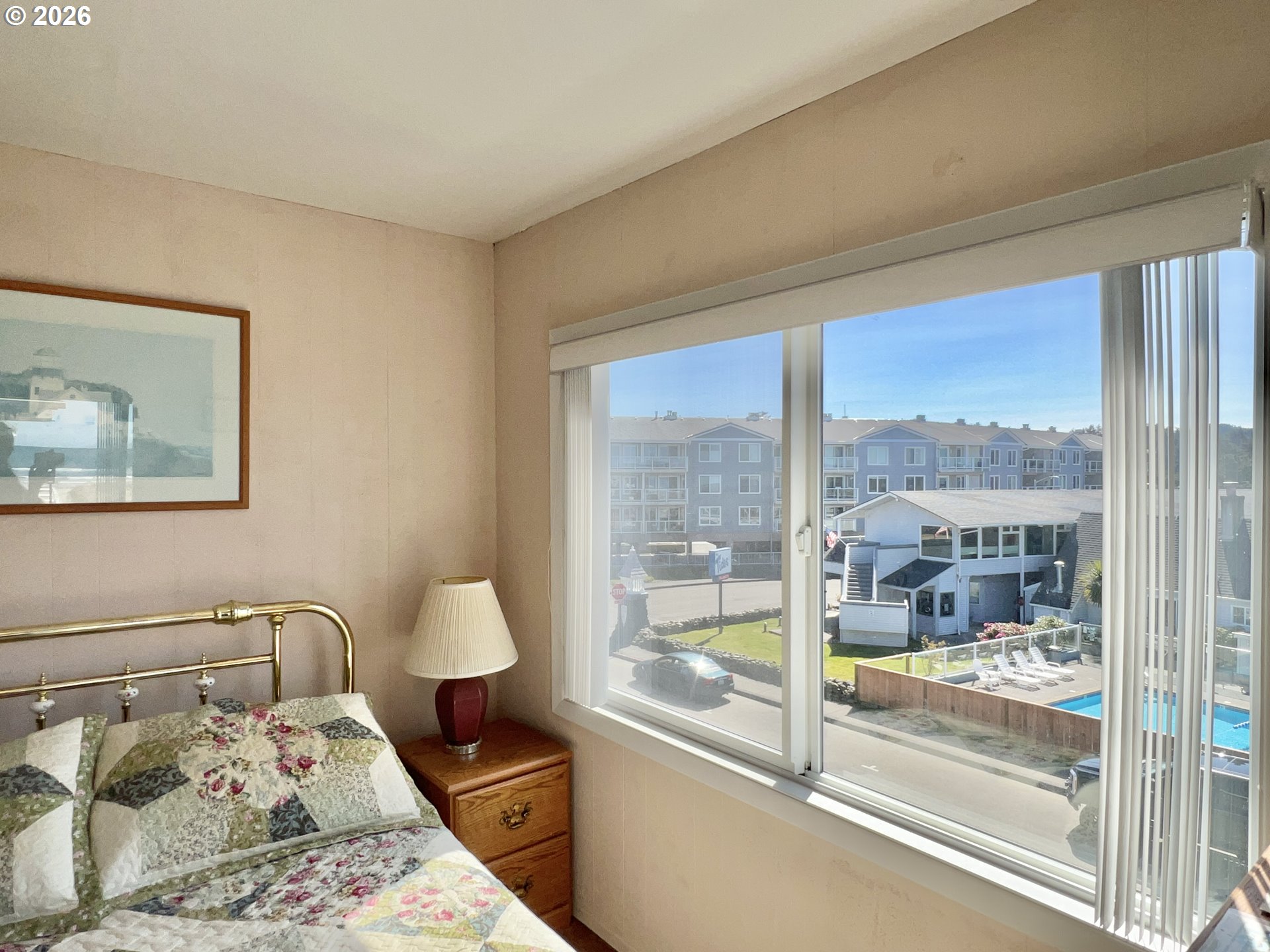 40 Avenue U, Unit 63 Seaside, OR 97138 - Photo 22 of 45 a bedroom with a large bed and a window