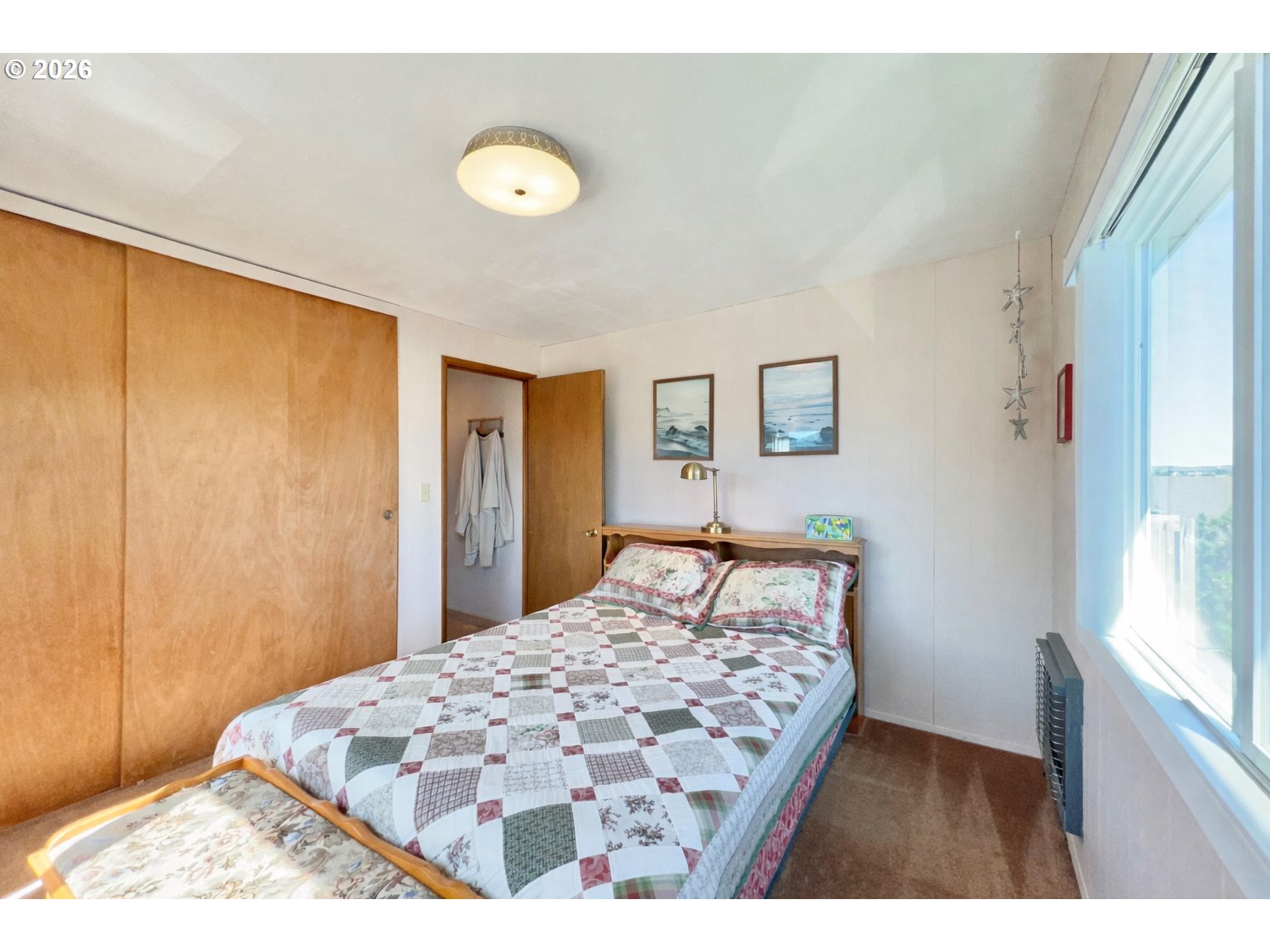 40 Avenue U, Unit 63 Seaside, OR 97138 - Photo 25 of 45 a bedroom with a bed and a window