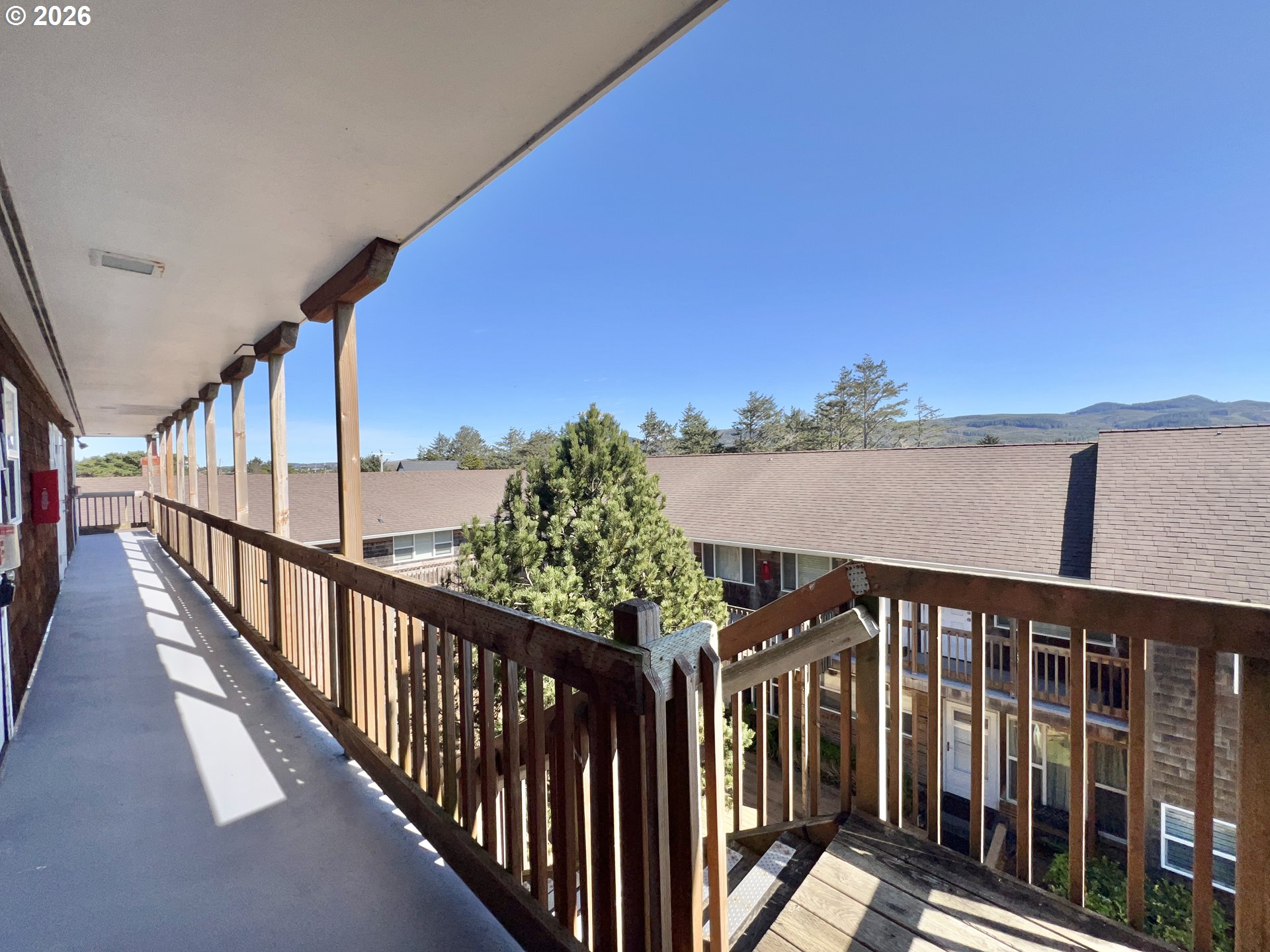 40 Avenue U, Unit 63 Seaside, OR 97138 - Photo 31 of 45 a view of a balcony with wooden fence and floor