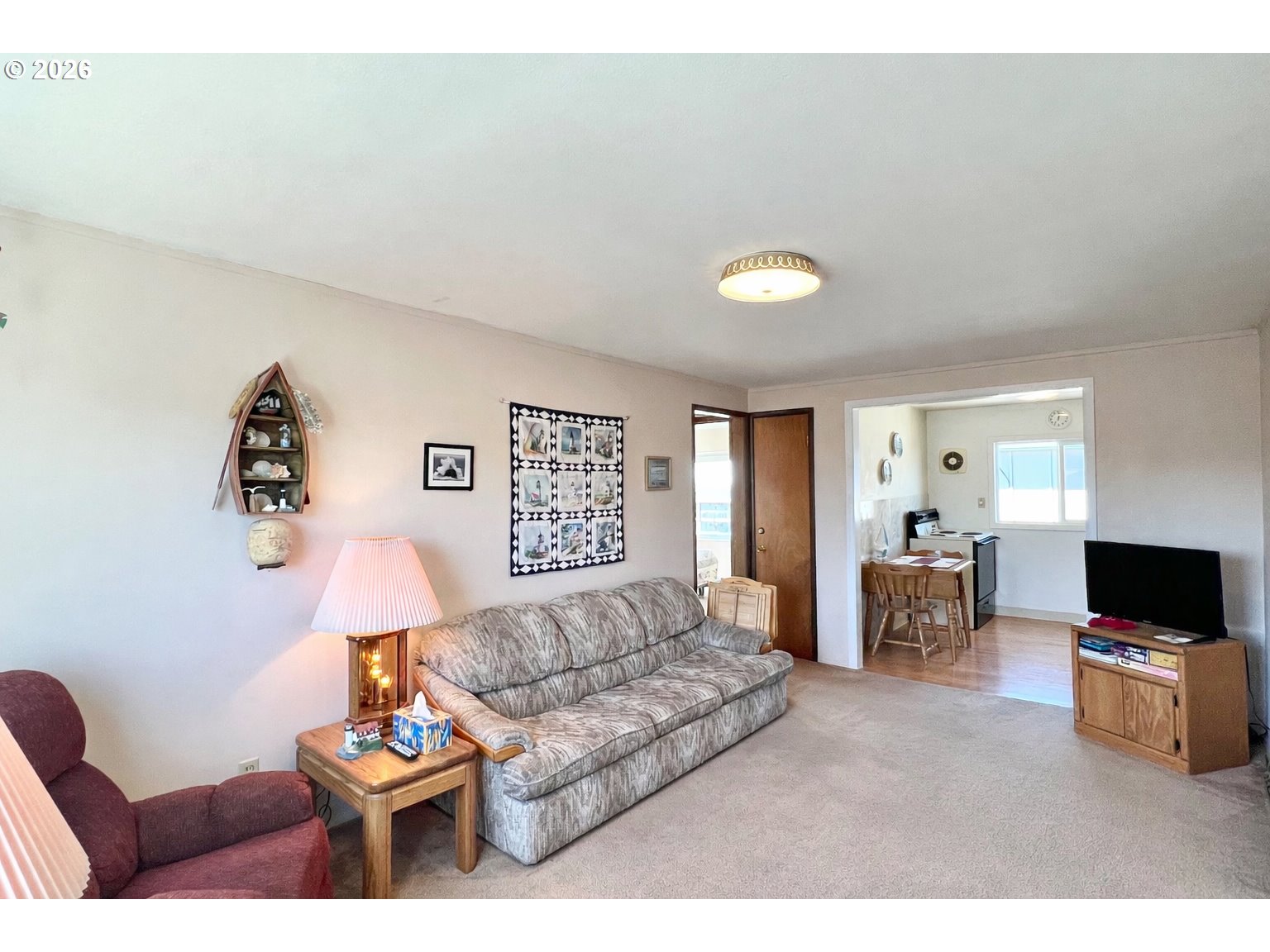 40 Avenue U, Unit 63 Seaside, OR 97138 - Photo 6 of 45 a living room with furniture and a flat screen tv