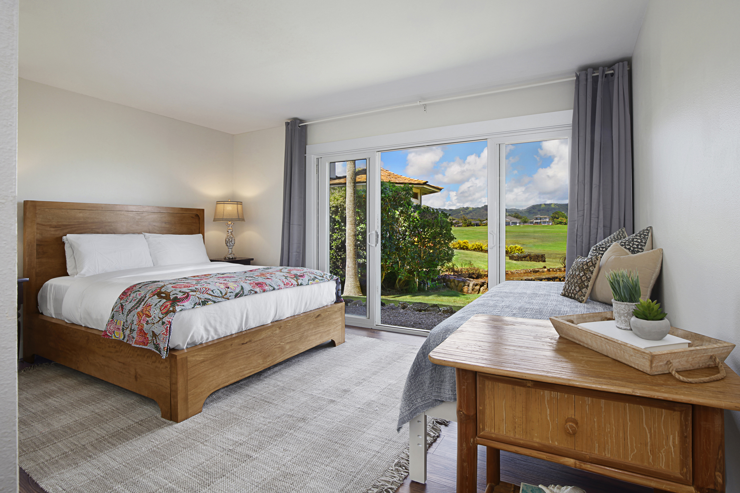 2750 Milo Hae Loop Koloa, HI 96756 - Photo 18 of 23 a bedroom with a bed and large windows