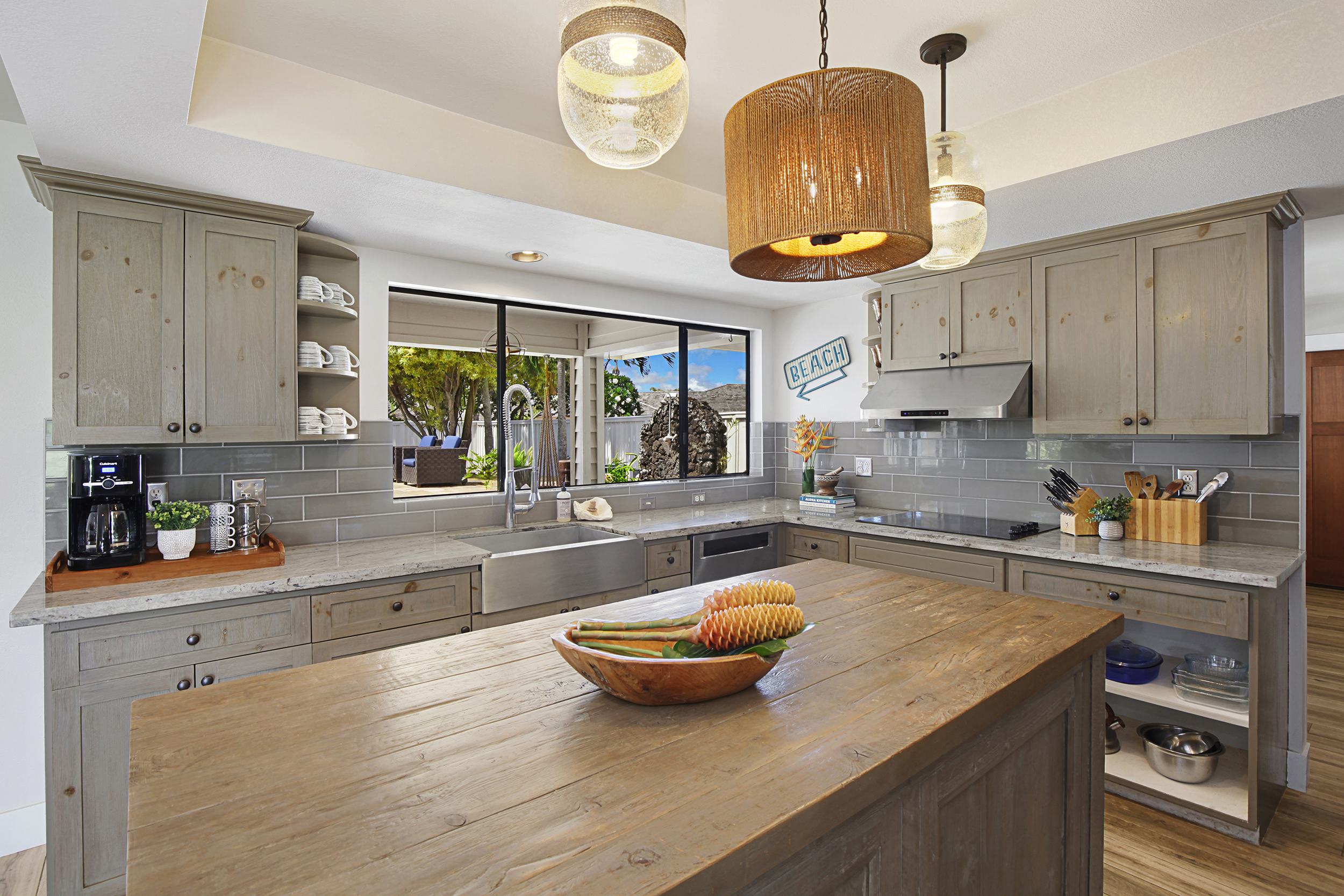 2750 Milo Hae Loop Koloa, HI 96756 - Photo 3 of 23 a kitchen with a sink a stove and cabinets